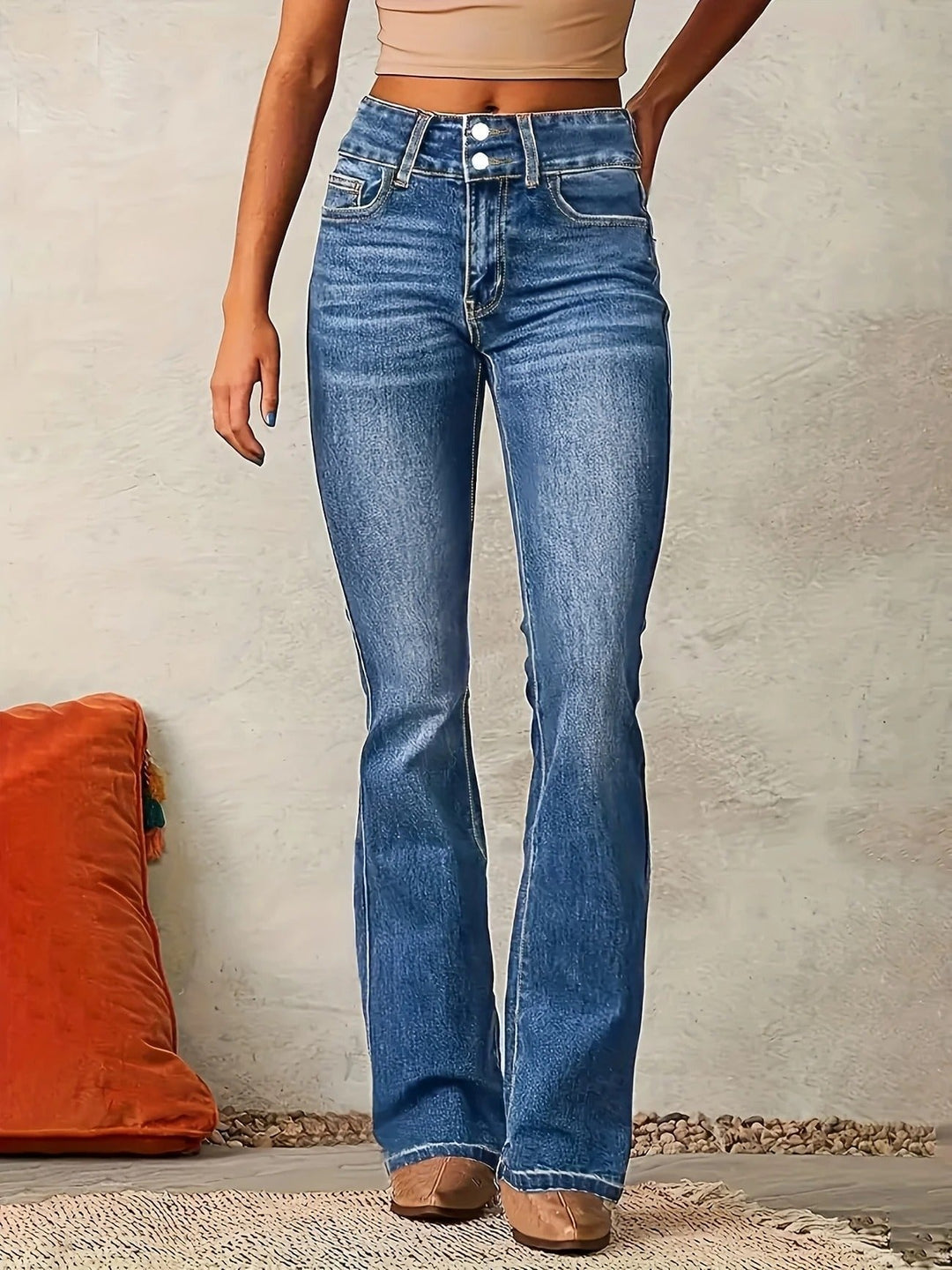 Women's high-waist sculpted flare jeans in a medium wash denim, perfect for an elongating, stylish look.