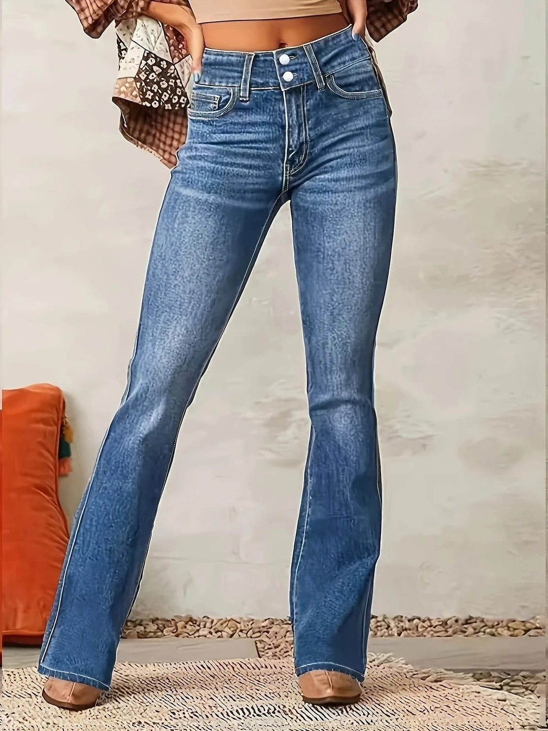 Blue denim high-waist flare jeans for women. Sculpted fit, medium wash, offering a stylish & versatile look.