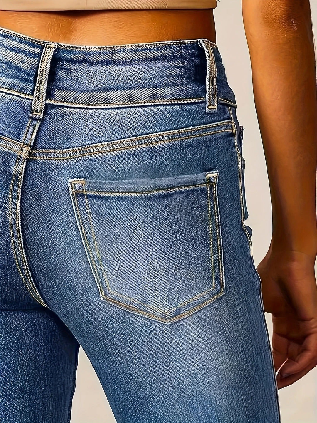 Elongating high-waist flare jeans for women. Sculpted medium wash denim offers comfort and a sleek, stylish profile.