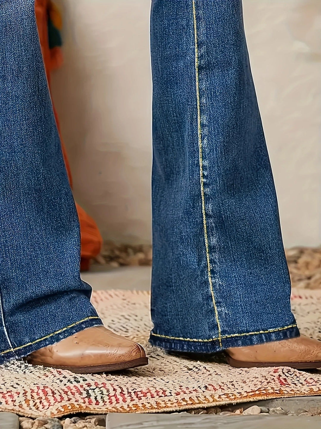 Women's medium wash high-waist flare jeans. Sculpted blue denim creates an elegant, elongating, and fashionable look.