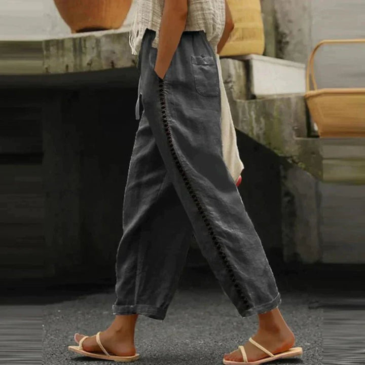Stylish women's high-waist pants with a flattering tapered leg & unique side button detail for modern women.