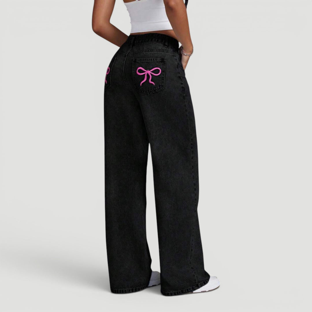 Women's high waist wide leg denim trousers with chic bow detail.