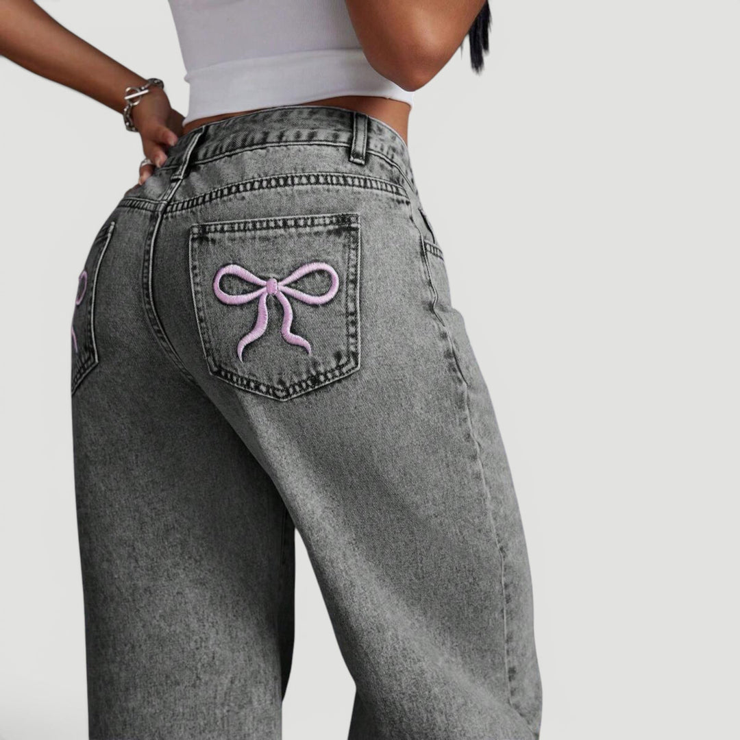 Relaxed fit women's high waist wide leg jeans with decorative bow.