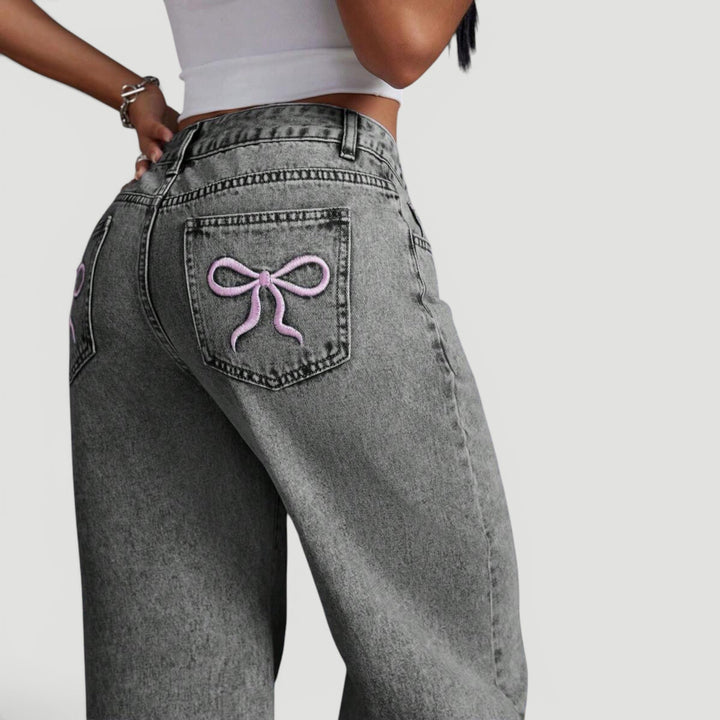 Relaxed fit women's high waist wide leg jeans with decorative bow.