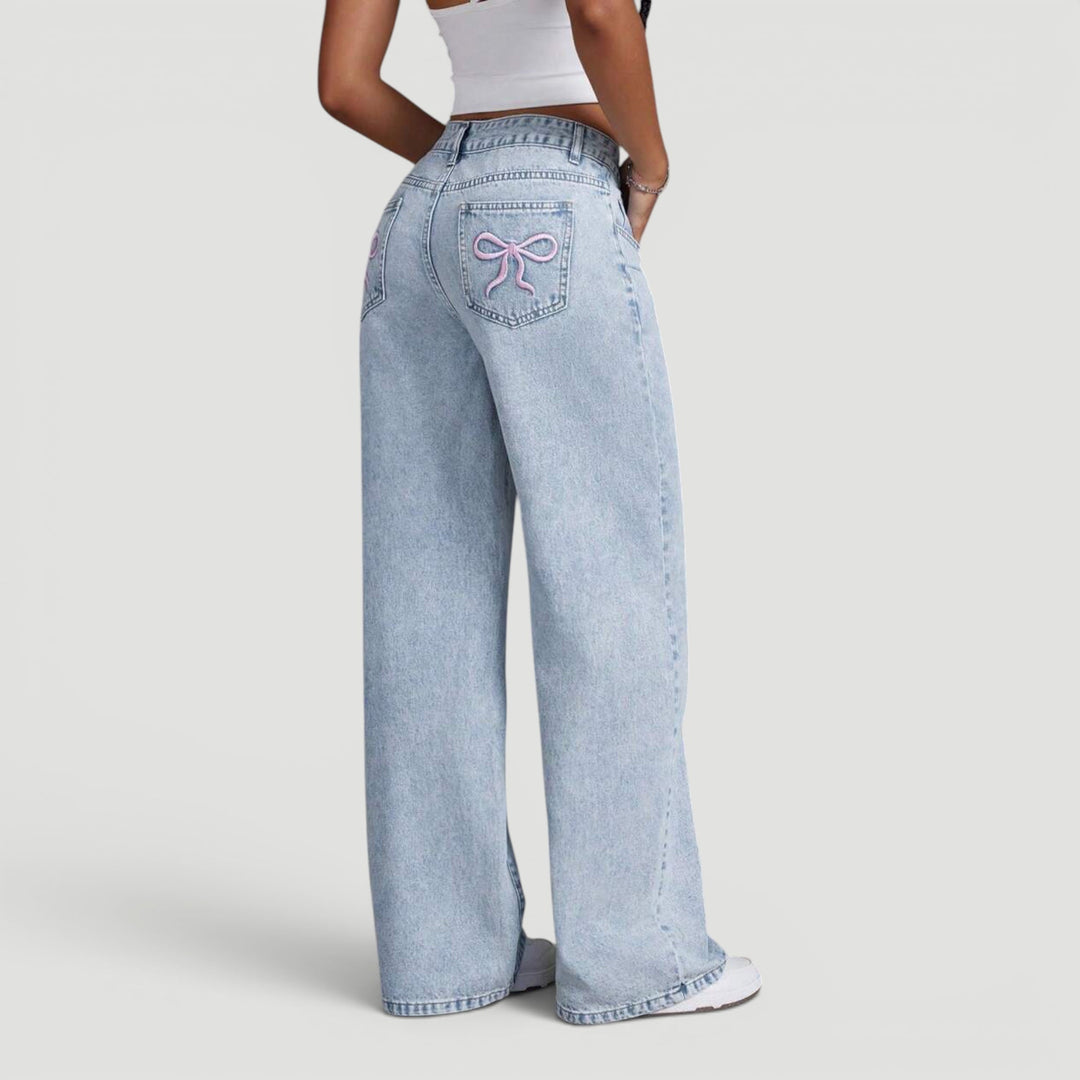 Fashionable high waist denim trousers, women's wide leg cut, bow detail.