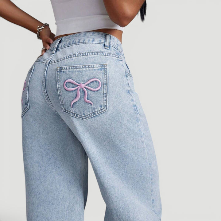 Modern women's wide leg denim trousers, high waist & subtle bow.