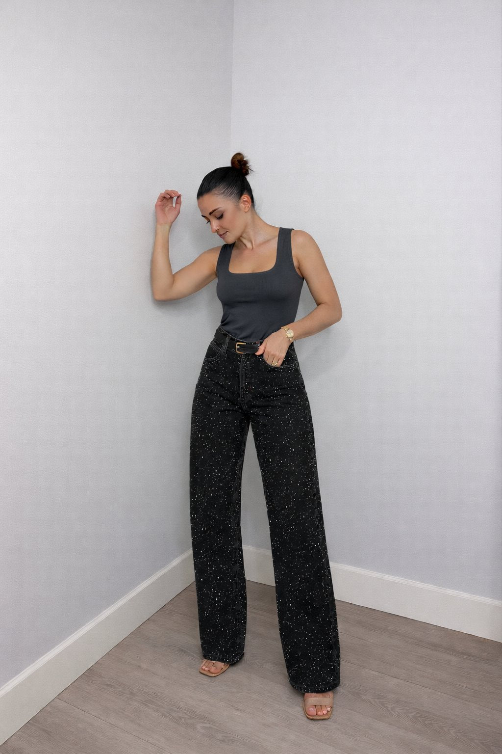 Women's high-waist wide-leg jeans with shimmering glitter denim. Fashionable party wear bottoms.
