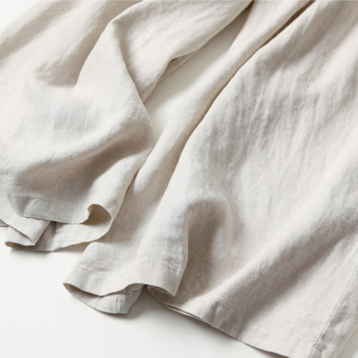 Modern women's work pants: high-waist, wide-leg, pleat front for a polished finish.