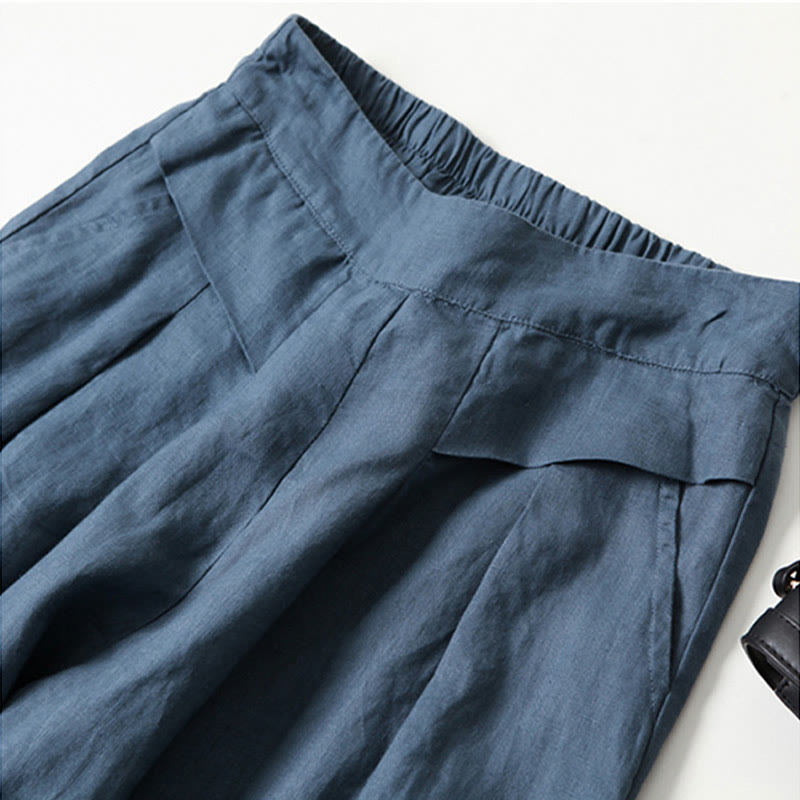Pleated high-waist wide-leg trousers for women, a stylish addition to any wardrobe.