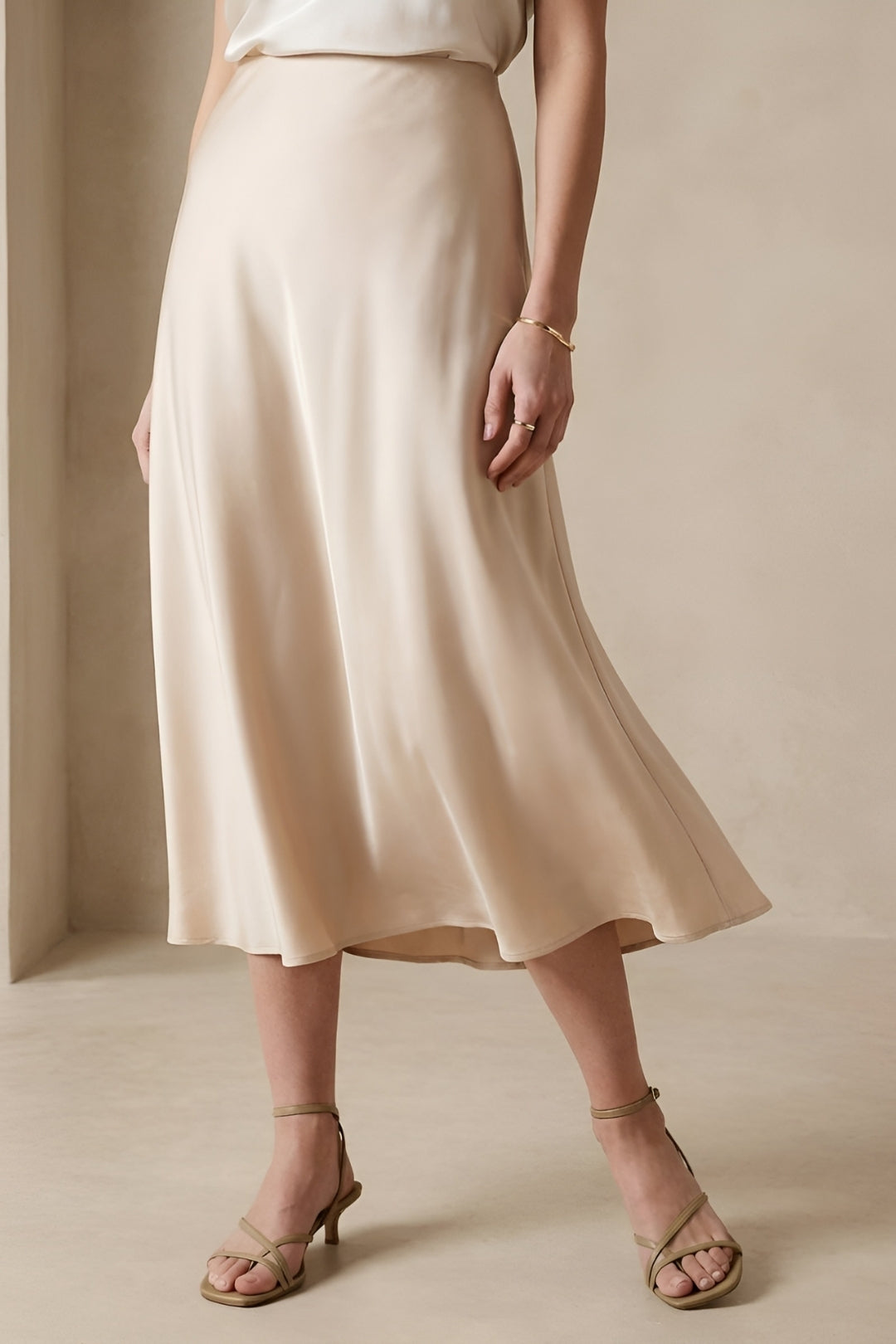 Chic women's A-line midi skirt with high waist, offering an elegant, flattering silhouette.