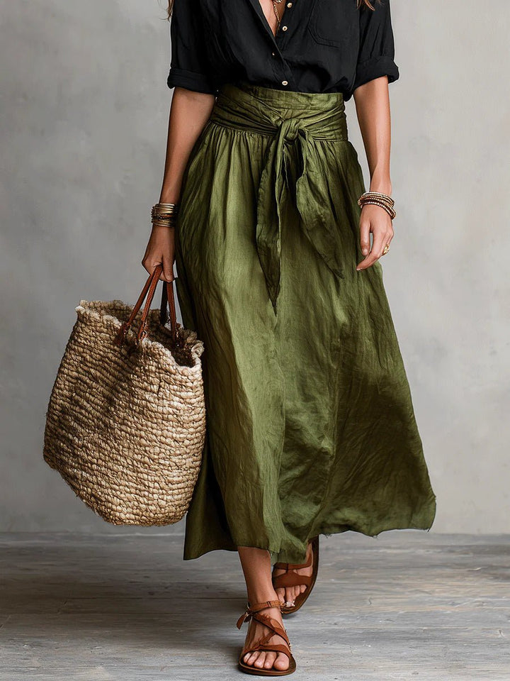 Women's elegant coordinated outfit: high-waisted maxi skirt & button-up V-neck top. Versatile for spring fashion.
