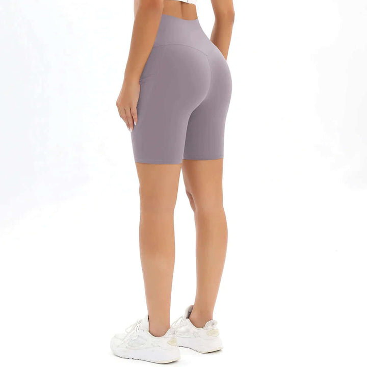 Modern women's high-waisted workout shorts with a convenient pocket, built for active women seeking comfort & style.