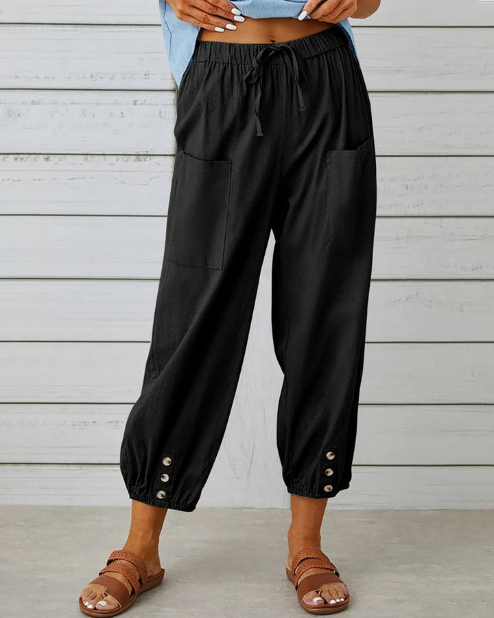 Woman walking in modern high-waisted loose fit casual pants, demonstrating comfortable, relaxed movement.