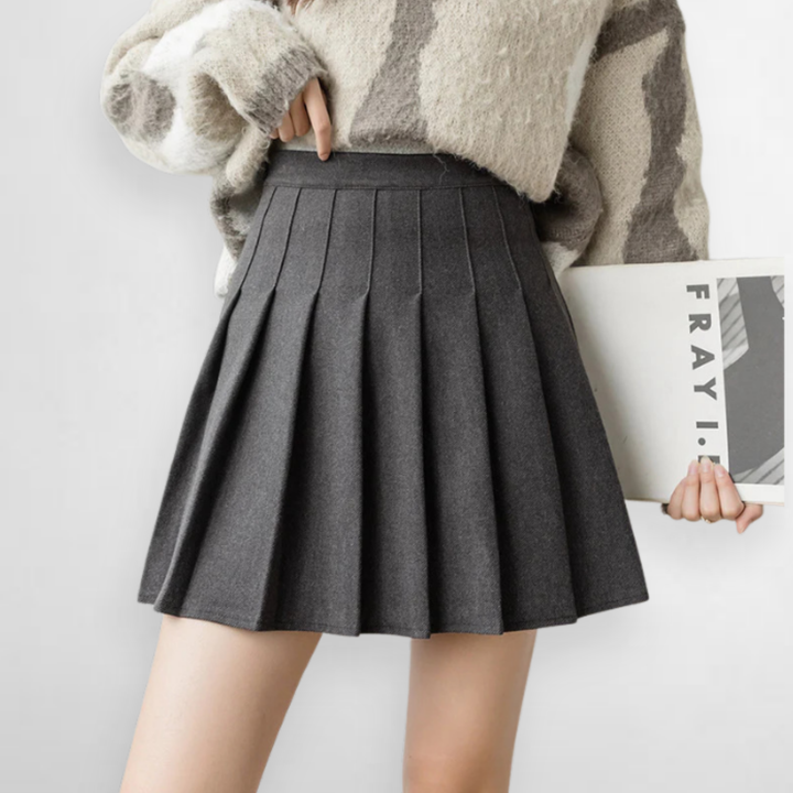 Gray high-waisted pleated mini skirt for women. Chic A-line style, perfect for office or casual fashion.