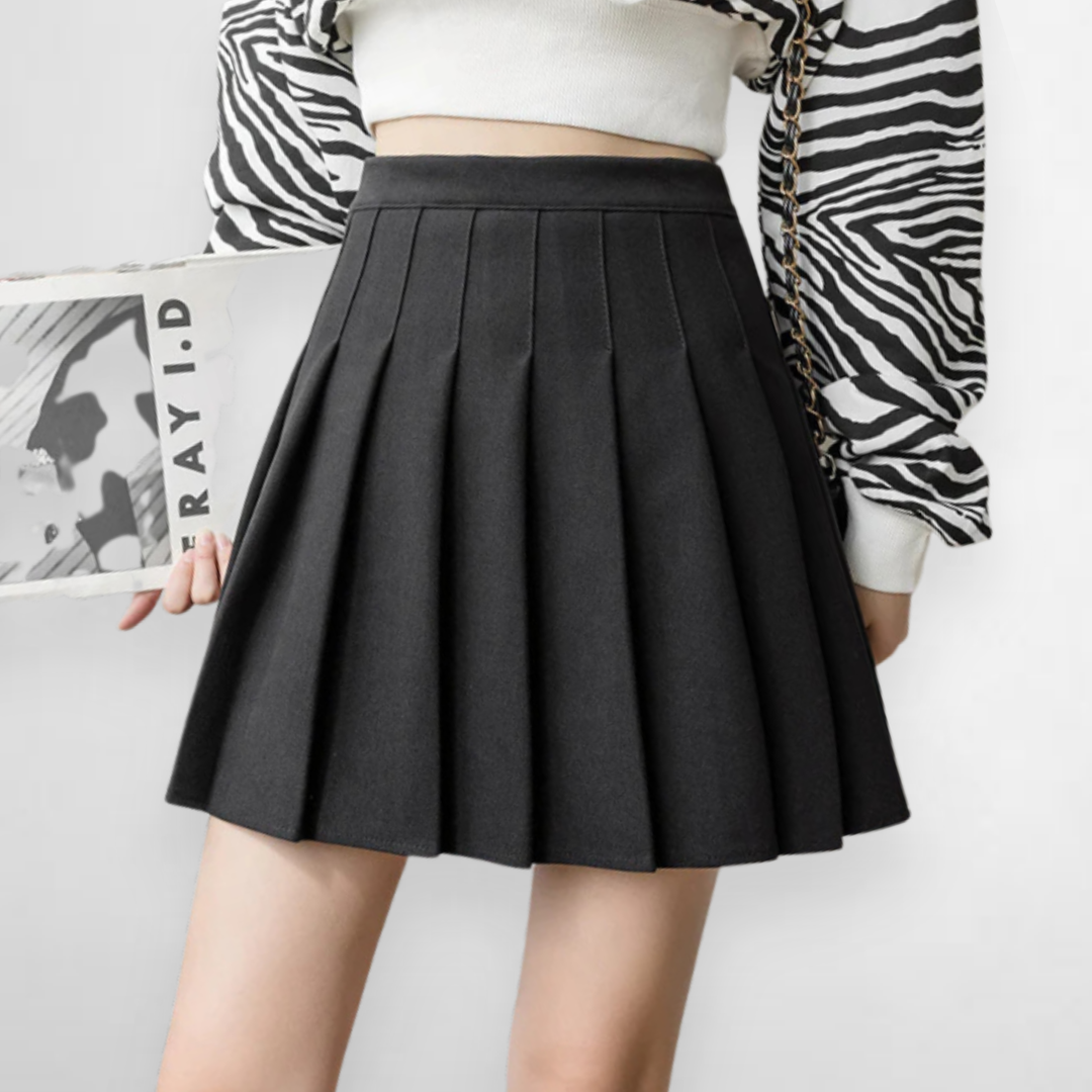 Versatile pleated mini skirt with a high waist for women. A-line design in multiple colors: beige, black, gray, brown.
