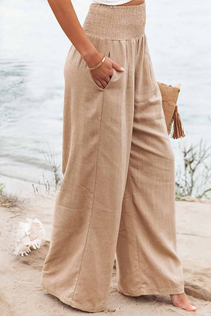 Comfortable women's smocked high-waisted pants with a flowing wide-leg. Versatile casual elegance.