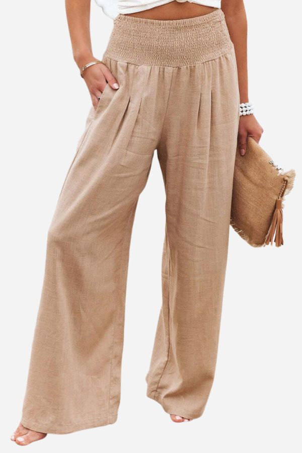 Elegant women's high-waisted smocked trousers. Wide-leg, flowing fit ideal for versatile fashion.