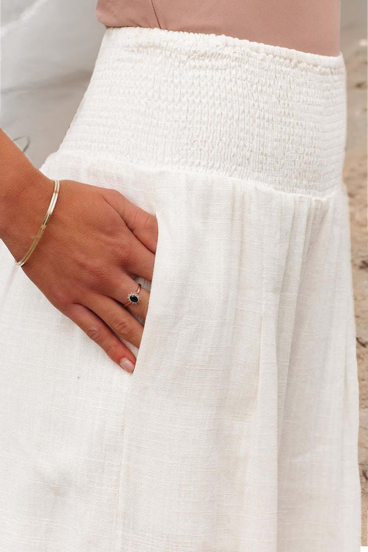 Lightweight, flowing women's high-waisted wide-leg pants featuring a comfortable smocked waist.