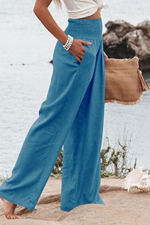 Women's flowing wide-leg smocked high-waisted trousers. Lightweight and comfortable for all-day wear.