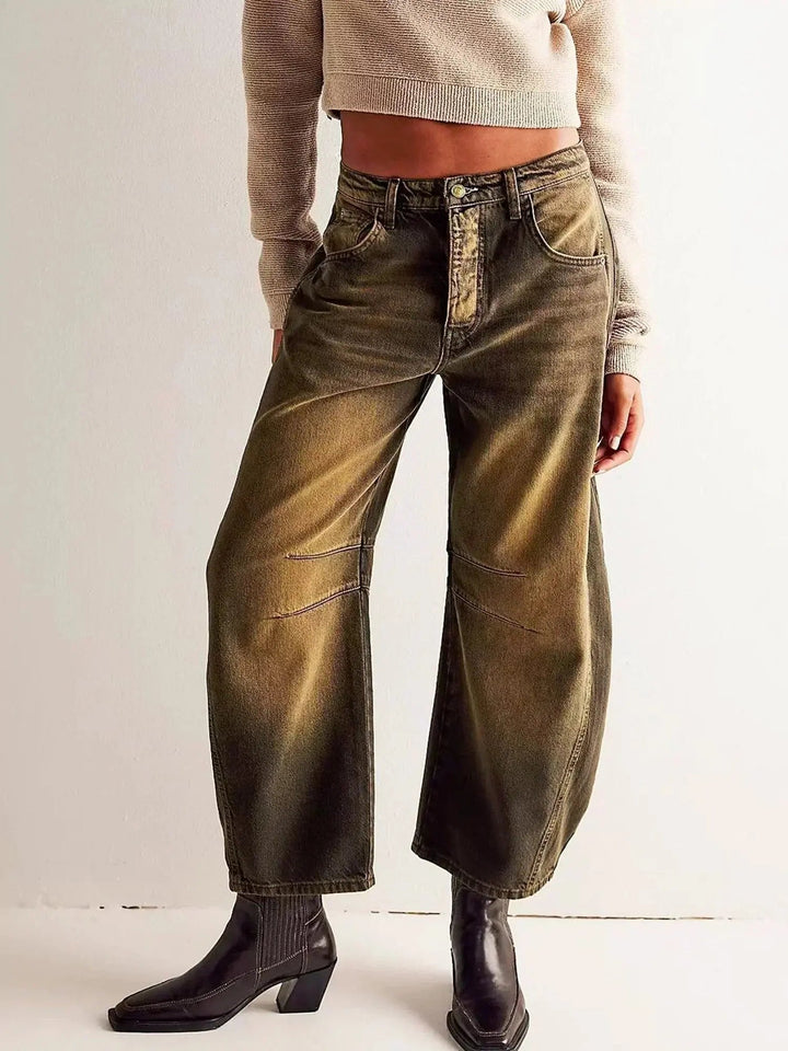 Fashionable women's high waisted animal print jeans, wide leg design.