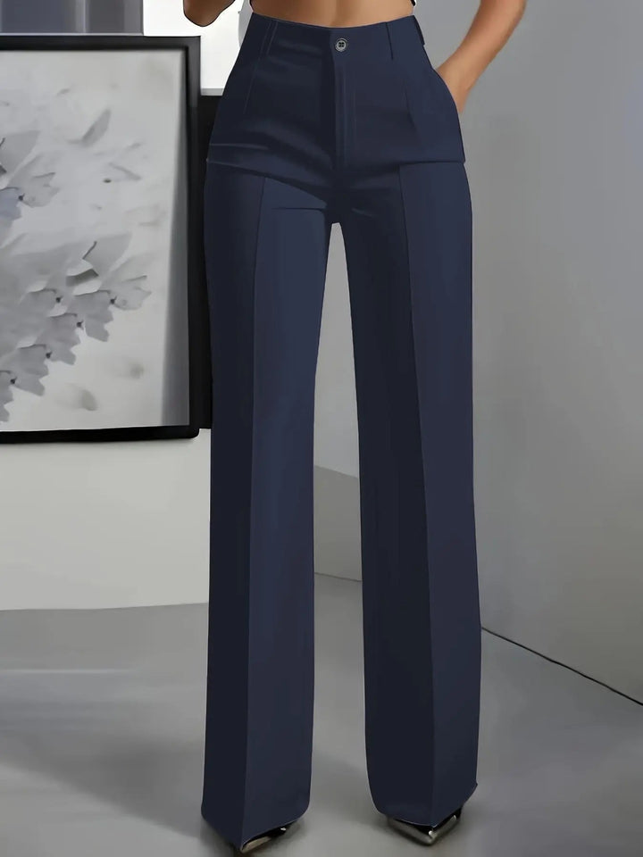 Women's high-waisted wide-leg pleated trousers. Elegant, tailored officewear pants for a sophisticated look.