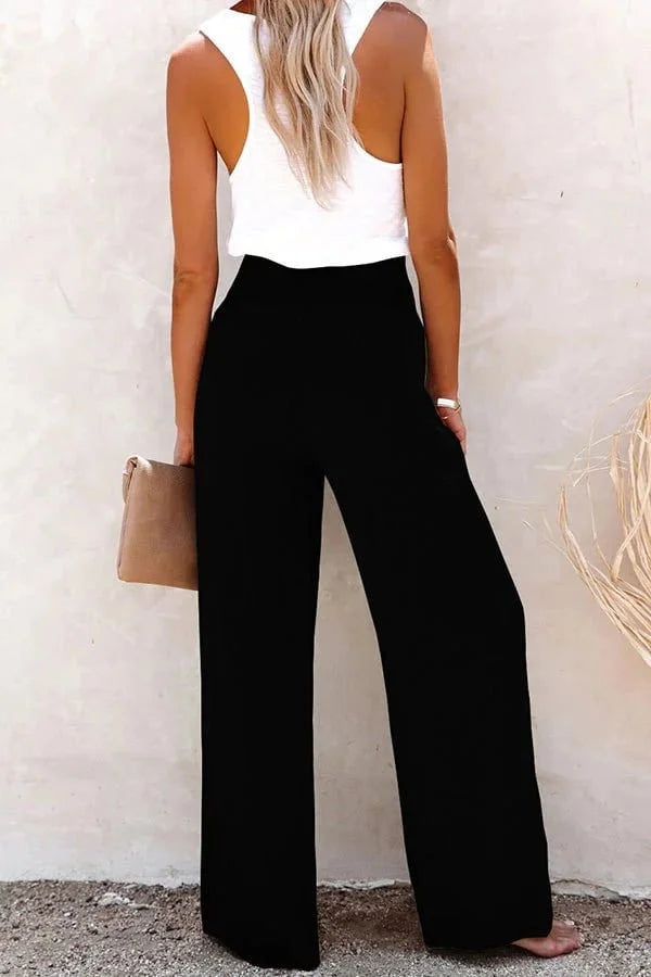 Flowy high-waisted wide-leg pants for women, featuring a stylish smocked front, perfect for summer fashion.