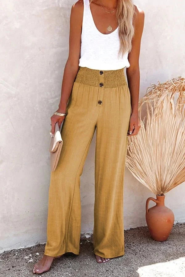 Women's high-waisted wide-leg summer pants with a smocked front, offering comfort and elegance.