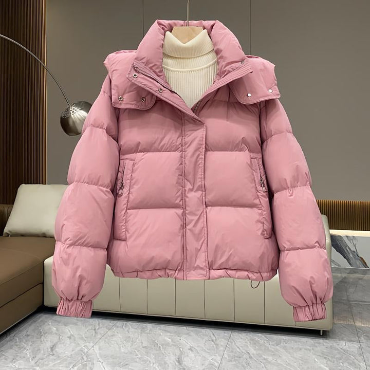 Lightweight yet warm women's hooded puffer jacket, high neck for winter protection.