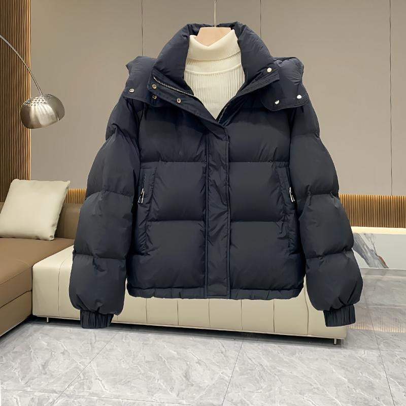 Stylish women's hooded puffer jacket, warm high neck winter outerwear for ladies.