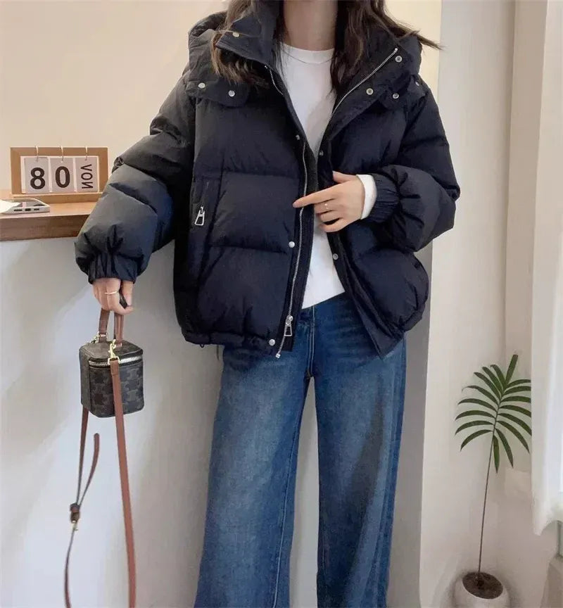 Ladies' fashionable hooded puffer jacket, high neck design for ultimate winter warmth.
