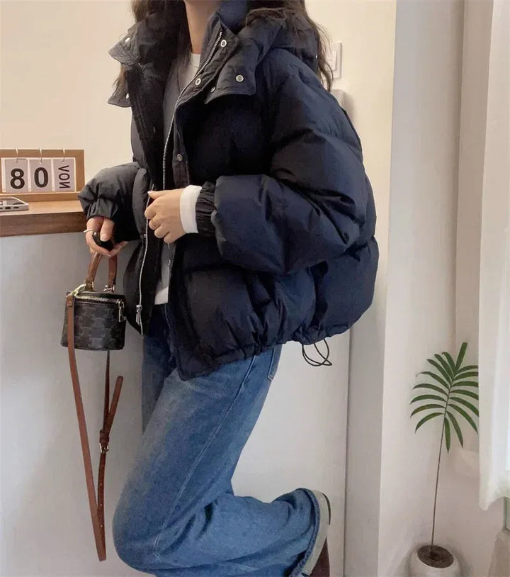 Women's warm hooded puffer jacket, essential high neck winter coat for chilly days.