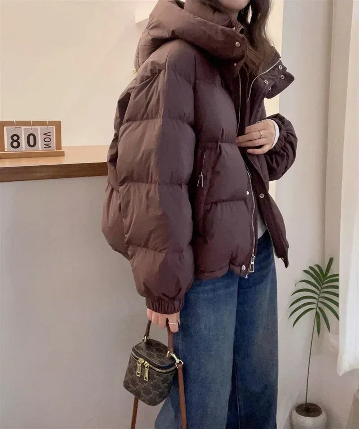 Practical women's hooded puffer jacket, warm high neck winter coat for everyday wear.