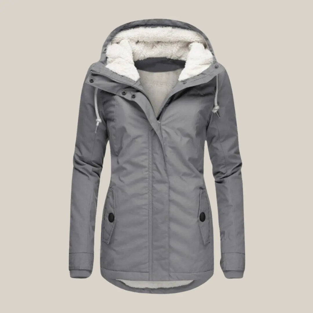 Stylish women's quilted winter jacket with hood. Durable fleece-lined outerwear for everyday wear.