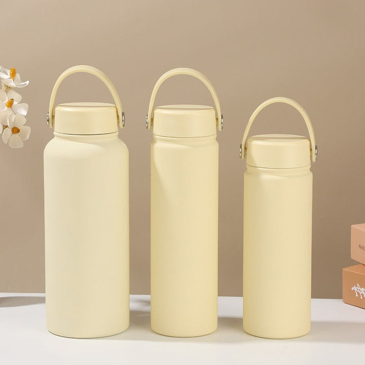 Hydration-focused women's insulated bottle, stainless steel with ergonomic carry handle, thermal design.