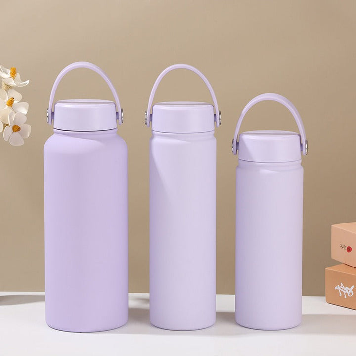 Women's stainless steel insulated water bottle with ergonomic handle for leak-proof, portable drinkware.