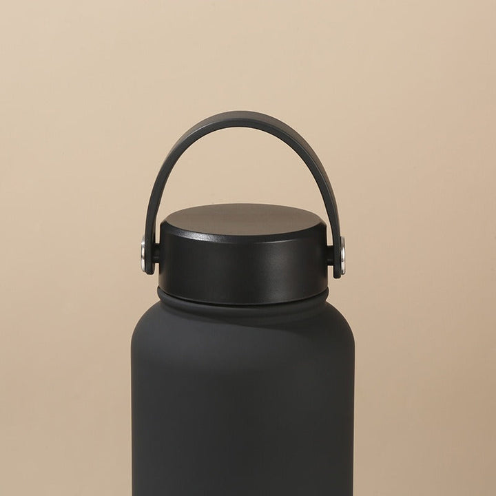 Leak-proof women's insulated water bottle, stainless steel, ergonomic carry handle for gym & travel.