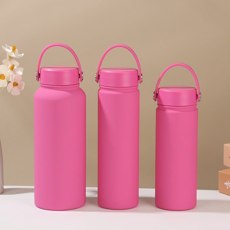 Gym-ready women's insulated water bottle with ergonomic carry handle, stainless steel, leak-proof hydration.