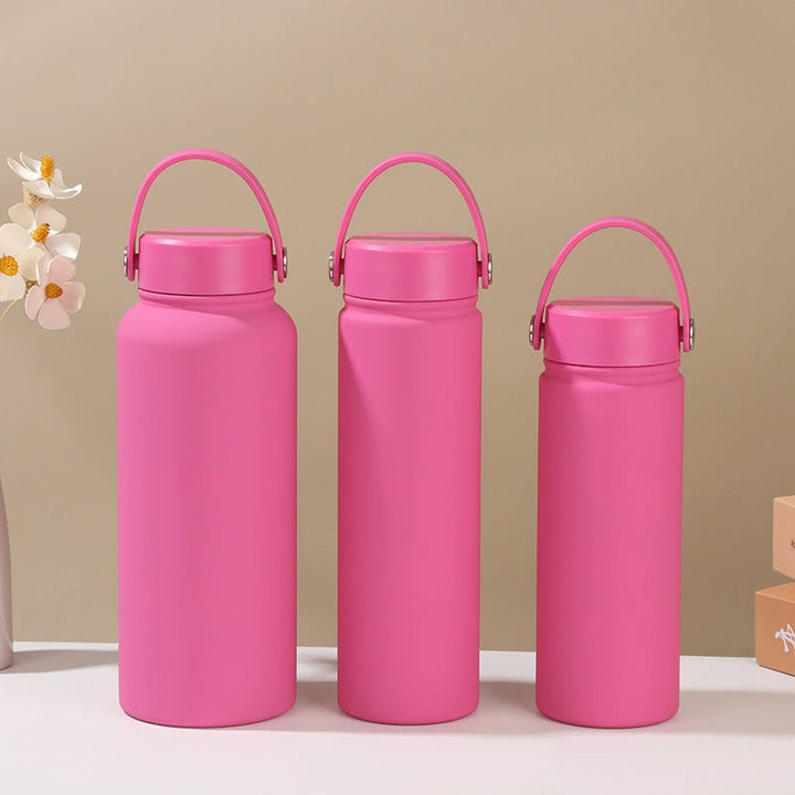 Gym-ready women's insulated water bottle with ergonomic carry handle, stainless steel, leak-proof hydration.