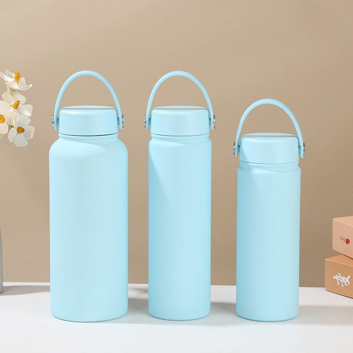 Women's thermal travel bottle, stainless steel, ergonomic handle for coffee, tea, or cold water.