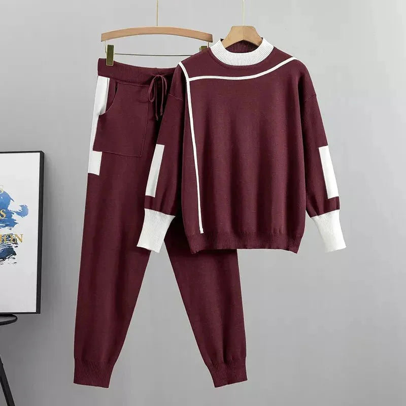 Women's knit color-block tracksuit. Mock-neck top & tapered trousers. Stylish athleisure two-piece set.