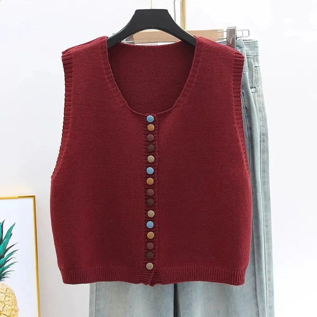 Sleeveless knit button-front cardigan vest for women, featuring a round neck & colorful buttons. Chic layering top.