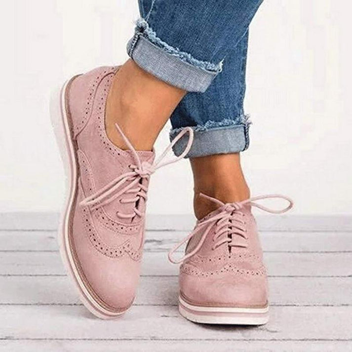 Women's lace-up brogue trainers with flat sole, offering comfort and elegant casual style for everyday wear.