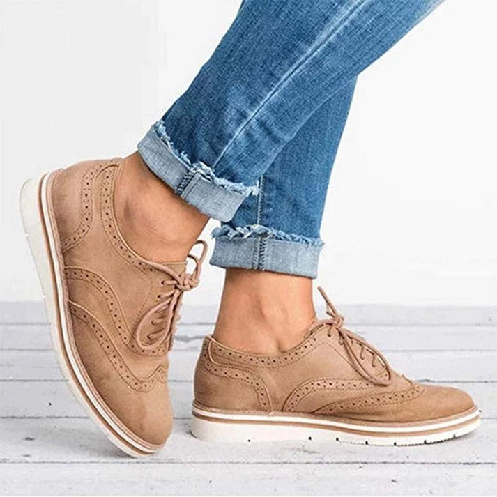 Stylish women's flat brogue trainers, lace-up design, perfect for walking and comfortable casual footwear fashion.
