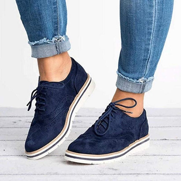 Comfortable women's oxford-style brogue trainers with a flat sole, lace-up closure for a secure, chic fit.