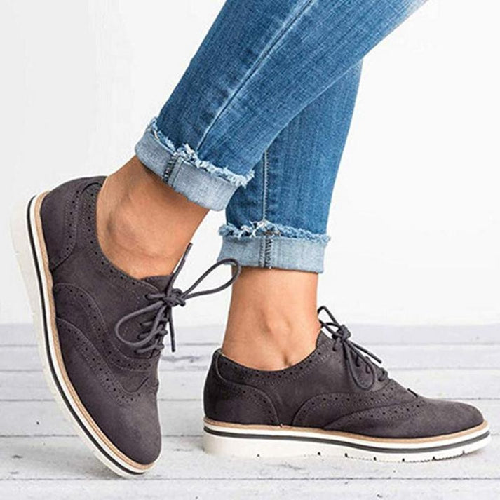 Elegant women's flat lace-up brogue trainers, versatile casual shoes for fashion and daily walking comfort.