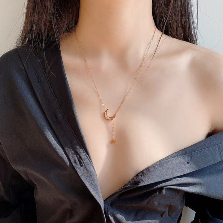 Women's layered celestial necklace with star and moon pendants, sterling silver, adjustable for fashion jewelry.