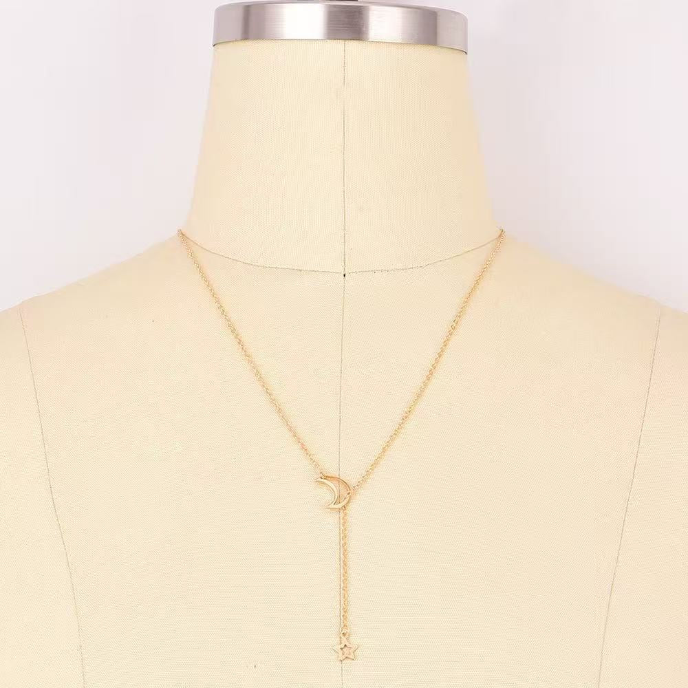 Sterling silver layered celestial necklace for women, showcasing star and moon pendants, perfect fashion accessory.