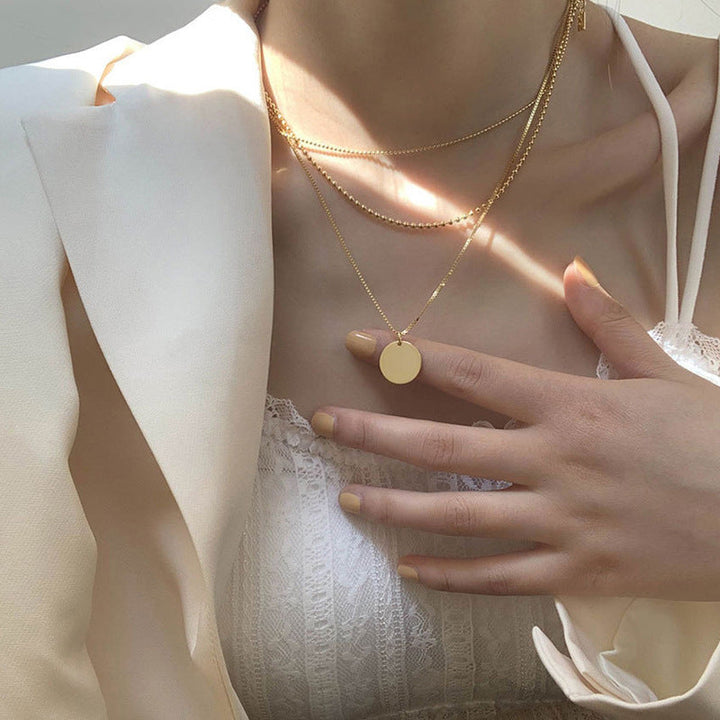 Dainty white layered pendant necklace for women, featuring a delicate chain & round charm. Ideal elegant gift for her.