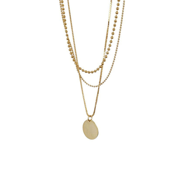 Women's fashion layered necklace with delicate chains and round pendant. Dainty & elegant accessory.