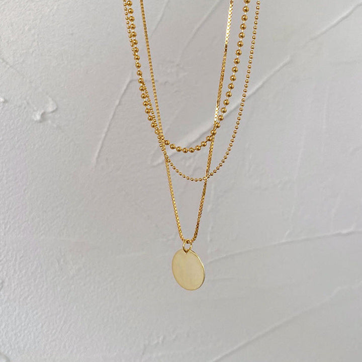 Delicate women's layered pendant necklace with a dainty chain & round white charm. Stylish fashion jewelry, great gift.